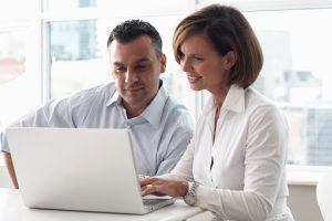 Man and Woman Using Laptop